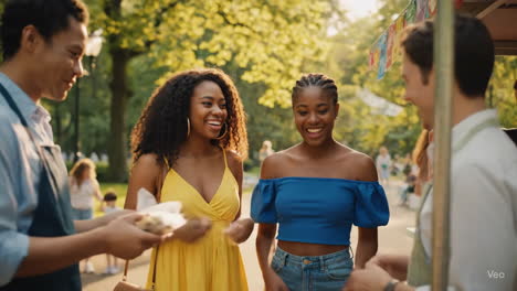 friends enjoying food at a park food truck