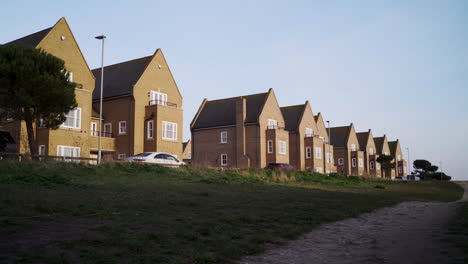 row of detached new build houses on outskirts of town. brick homes in countryside. residential buildings