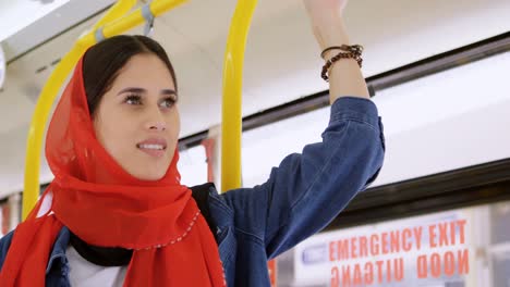 woman in hijab standing while travelling in the bus 4k