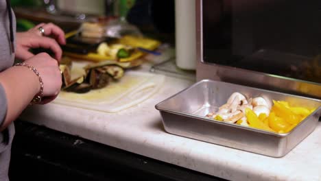 a wider view of cutting various vegetables on top of a kitchen counter