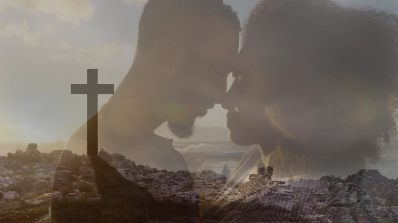 Embracing couple silhouetted against rocky landscape with cross, creating animation