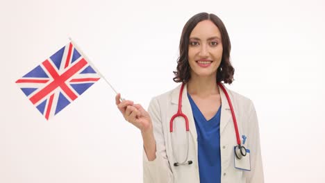 a smiling female doctor holding a british flag