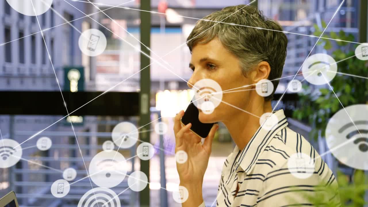 Animation of network of connections over happy caucasian businesswoman using smartphone