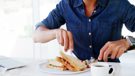 man eating lunch with coffee