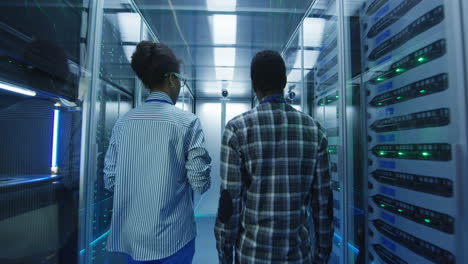 it professionals walking through a data center