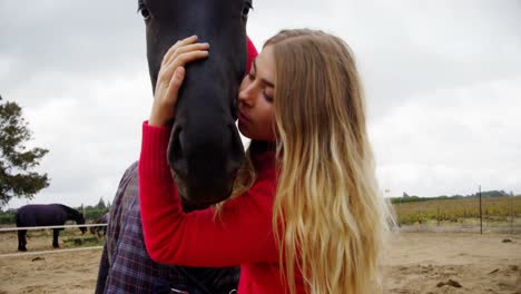 woman kissing horse in ranch 4k