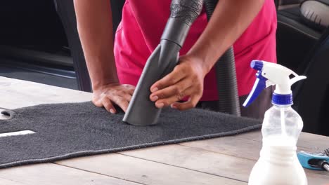 cleaning a car interior floor mat