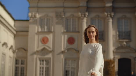 woman in white sweater at palace