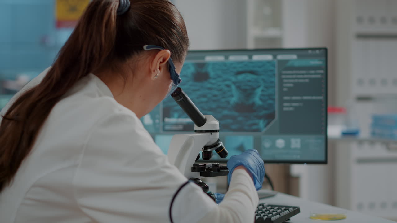 Biology scientist working with microscopic tool in laboratory