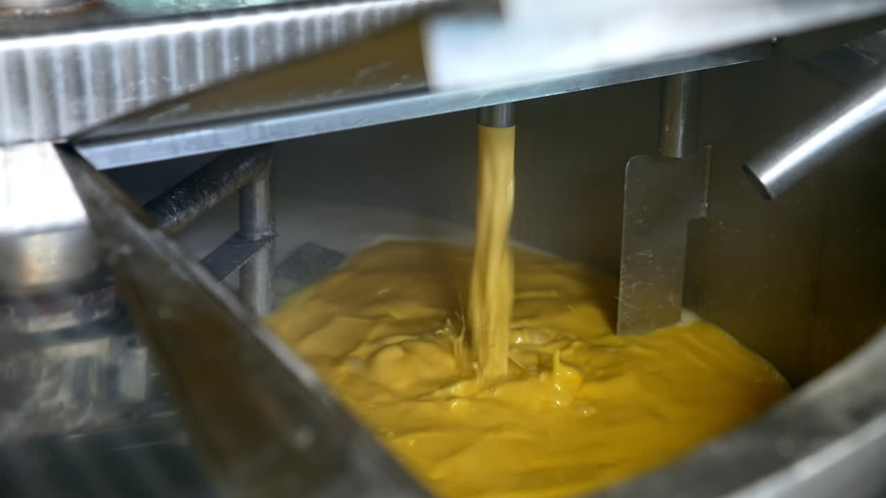 Industrial making cheese in big factory. Producing butter food industry.