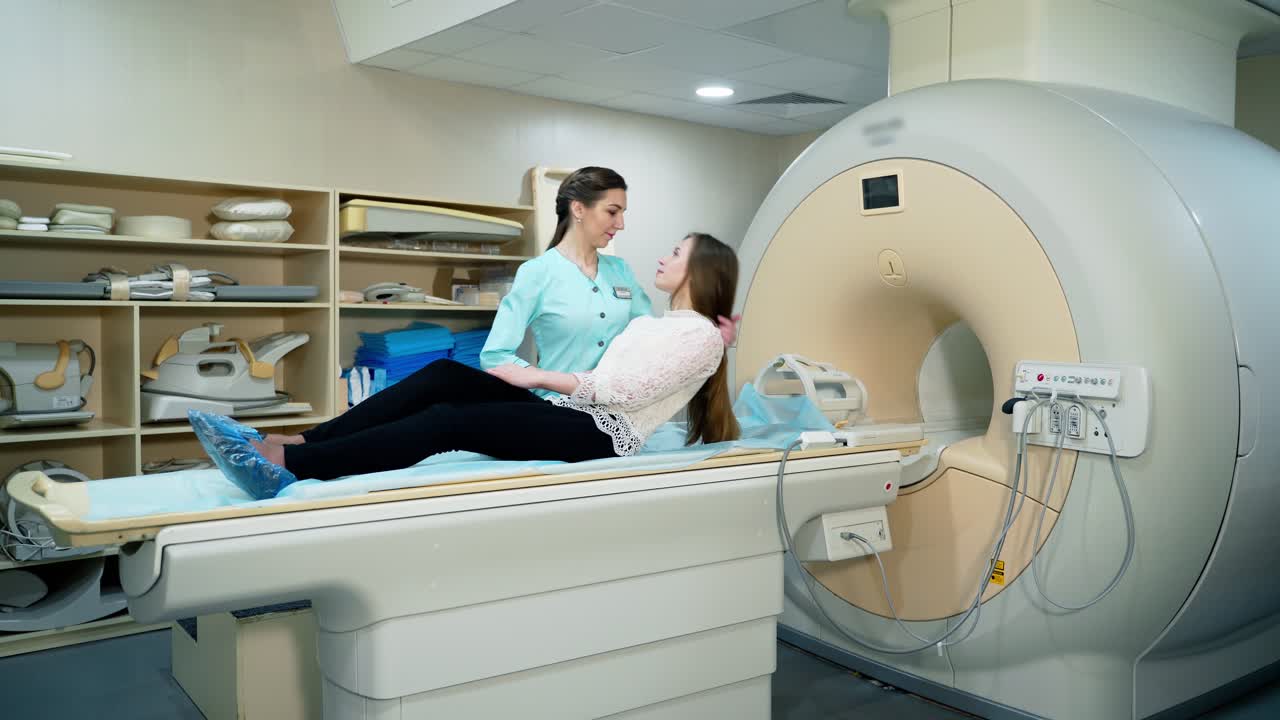 Young woman doing mri procedure in modern clinic. Female patient lying on a medical table machine before tomography examination. Contemporary equipment in medicine.