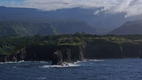 Aerial-orbit-of-tall-eroded-basalt-rock-spires-off-coast-of-Maui-North-shore-from-road-to-hana