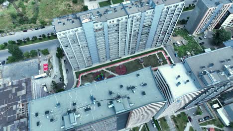 Aerial-view-of-an-urban-landscape-featuring-high-rise-buildings,-roads,-and-a-bustling-city-environment,-capturing-the-essence-of-metropolitan-life