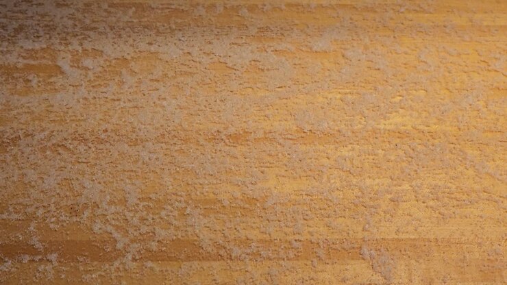 shuffleboard puck sliding across cheese covered board viewed from above