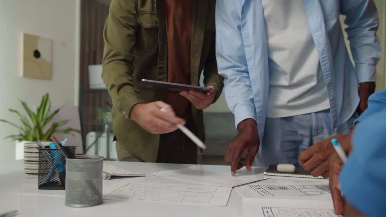 Developers Meeting at Office to Discuss Interface of App near Table
