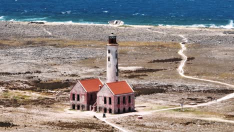 the drone is flying around the lighthouse of little curacao with a telephotolens in curacao aerial footage 4k