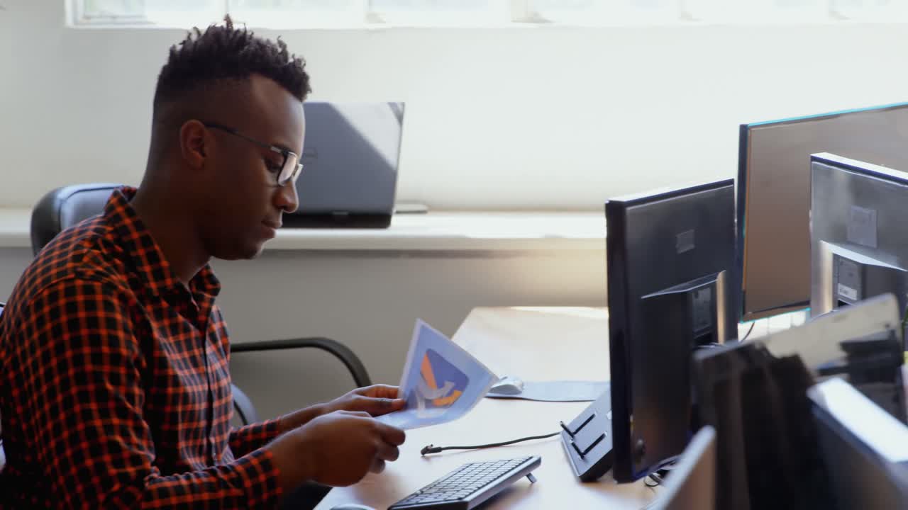 Side view of young cool mixed-race business team working at desk in a modern office 4k