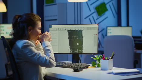 engineer working late night at industrial turbine drinking coffee