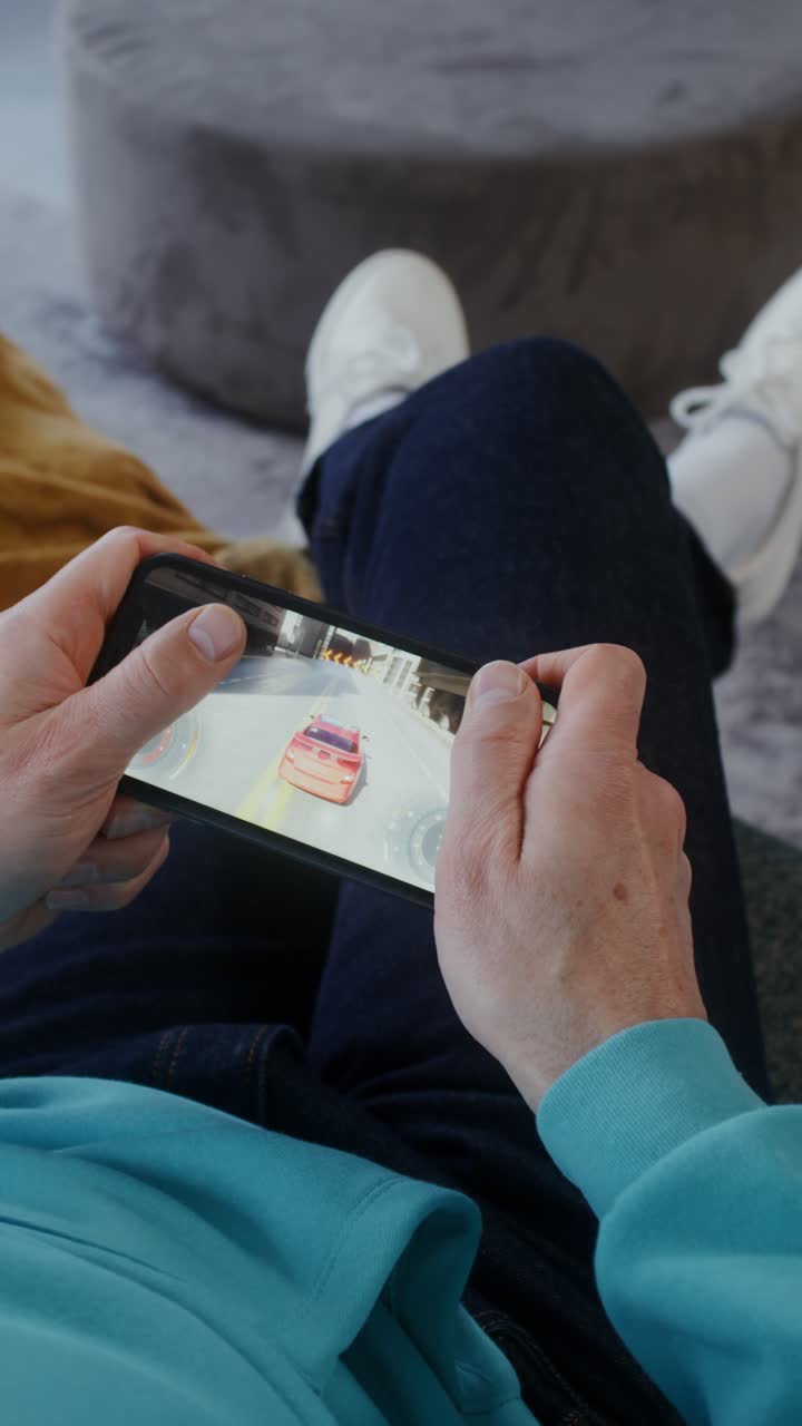 Person playing a car racing mobile game