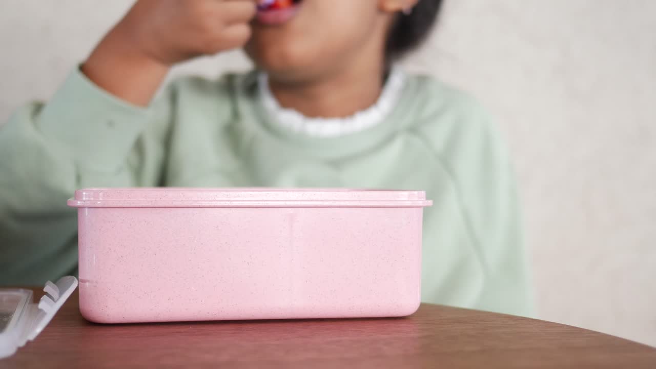 Child Eating a Strawberry from Lunchbox