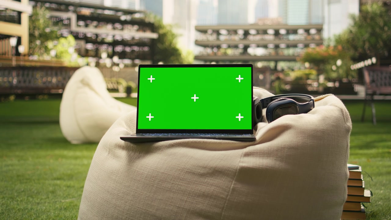 Laptop isolato con schermo chroma key posizionato su un pouf universitario