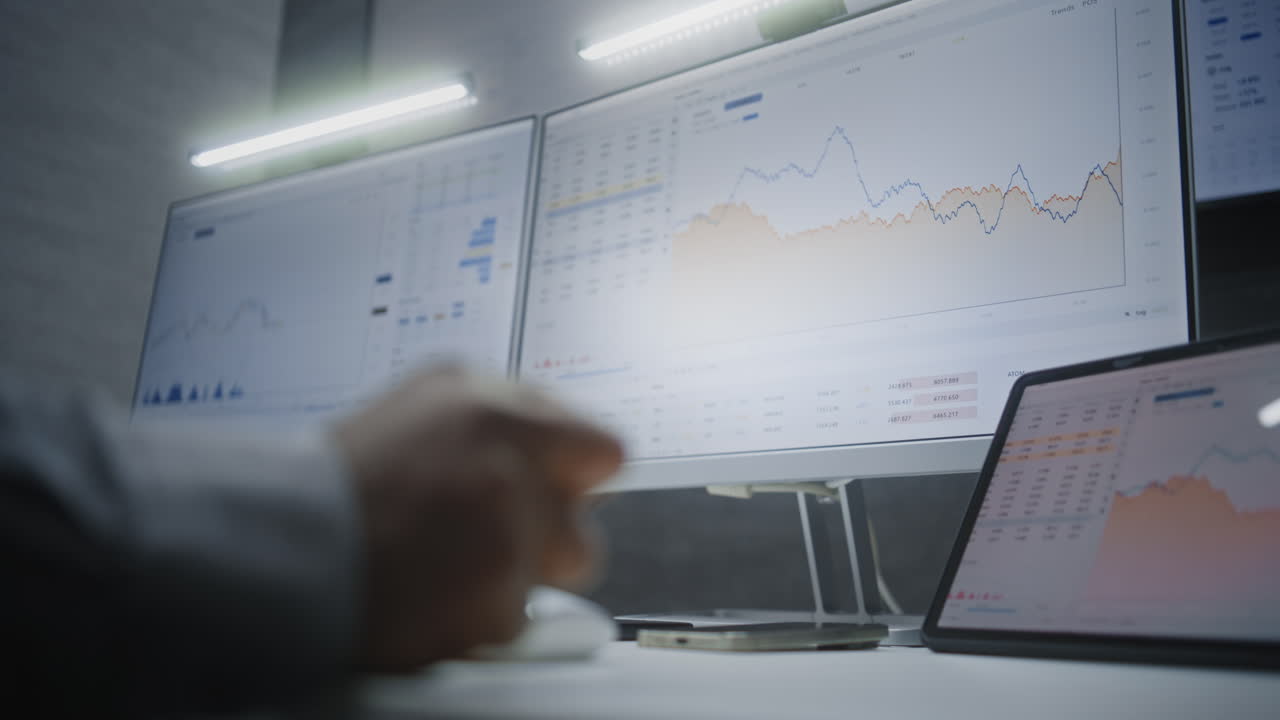 Stock Exchange Broker Monitoring Real-Time Stocks, Exchange Market Charts on Computer with Multi-Monitor Desktop Setup, Talking on Phone. African American Investment Agent in Office. Vertical Shot.