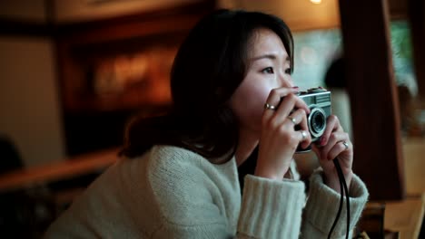 woman taking photo in cafe