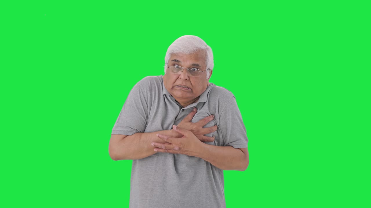 Sick Indian old man having a heart attack Green screen