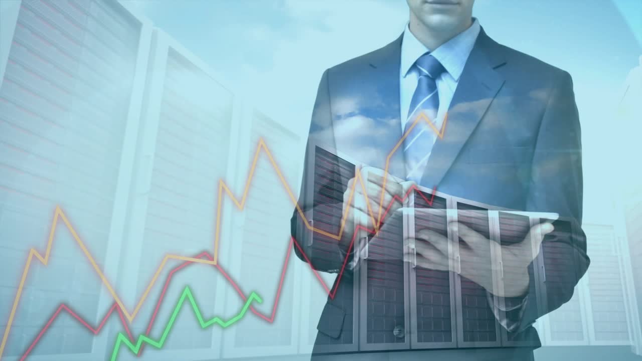 Male IT pro tapping tablet orange red green charts converging upward inspecting peak in datacenter