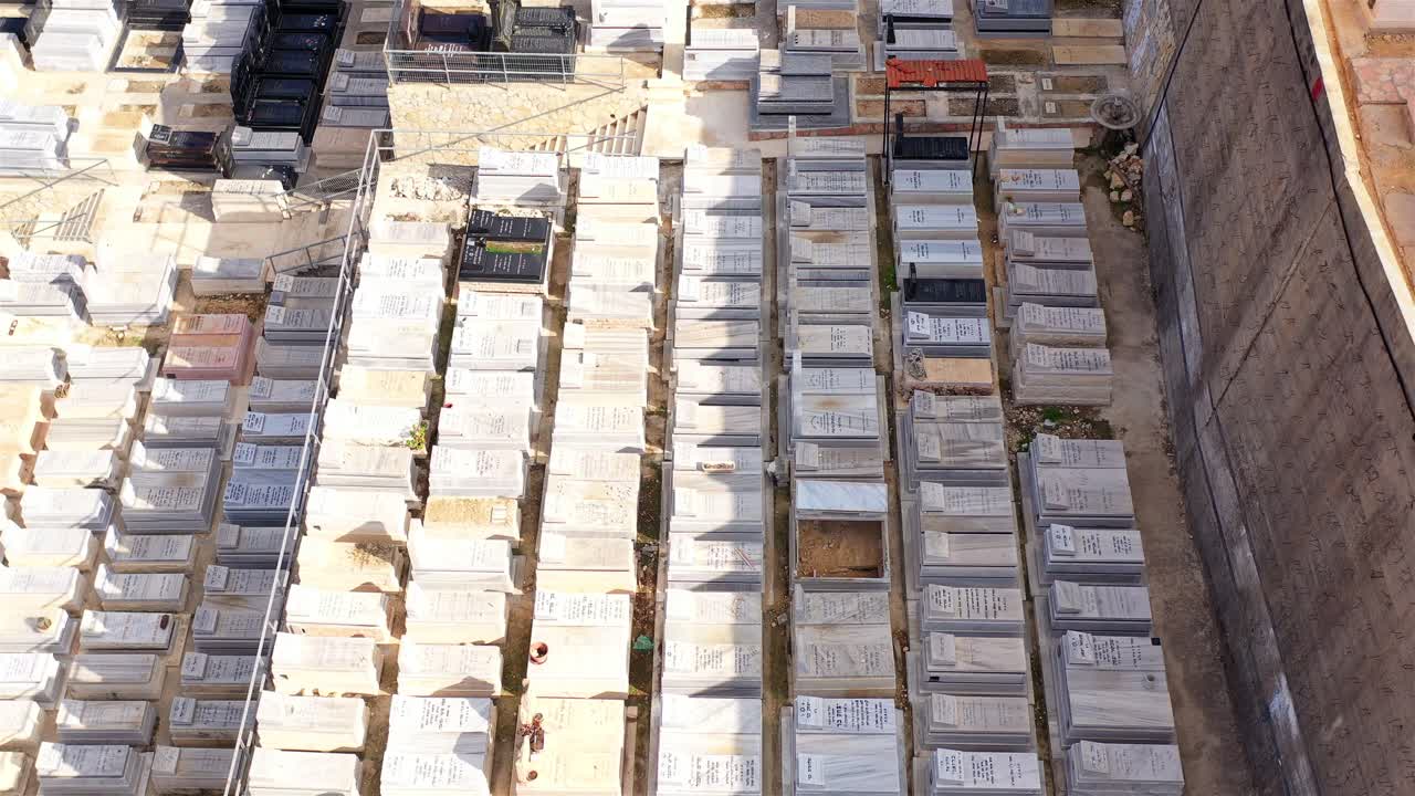 Aerial view of a vast cemetery with rows of gravestones