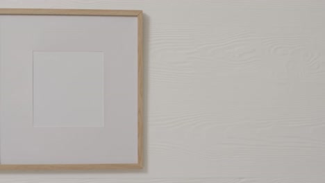 Wooden-frame-with-copy-space-with-white-background-and-white-wall