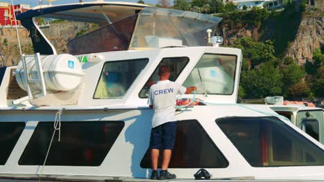 crew member cleaning boat windows in sorrento