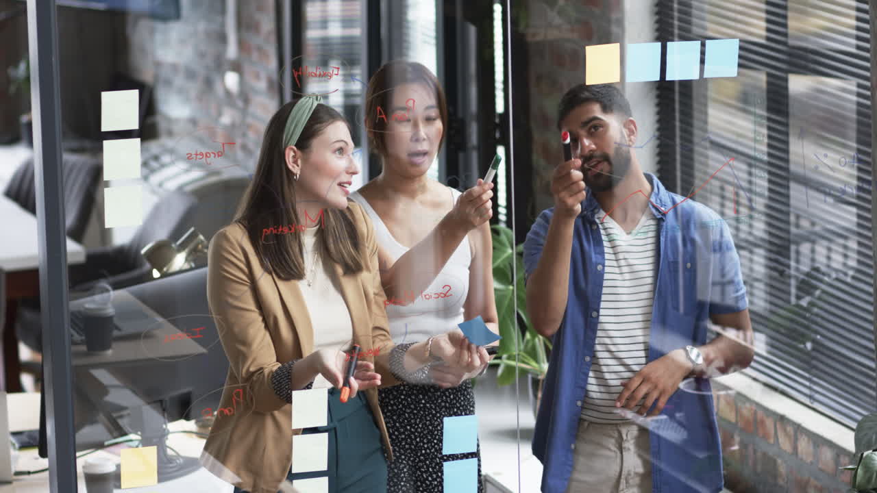 Middle-aged Asian woman, wearing green top, focusing on laptop screen