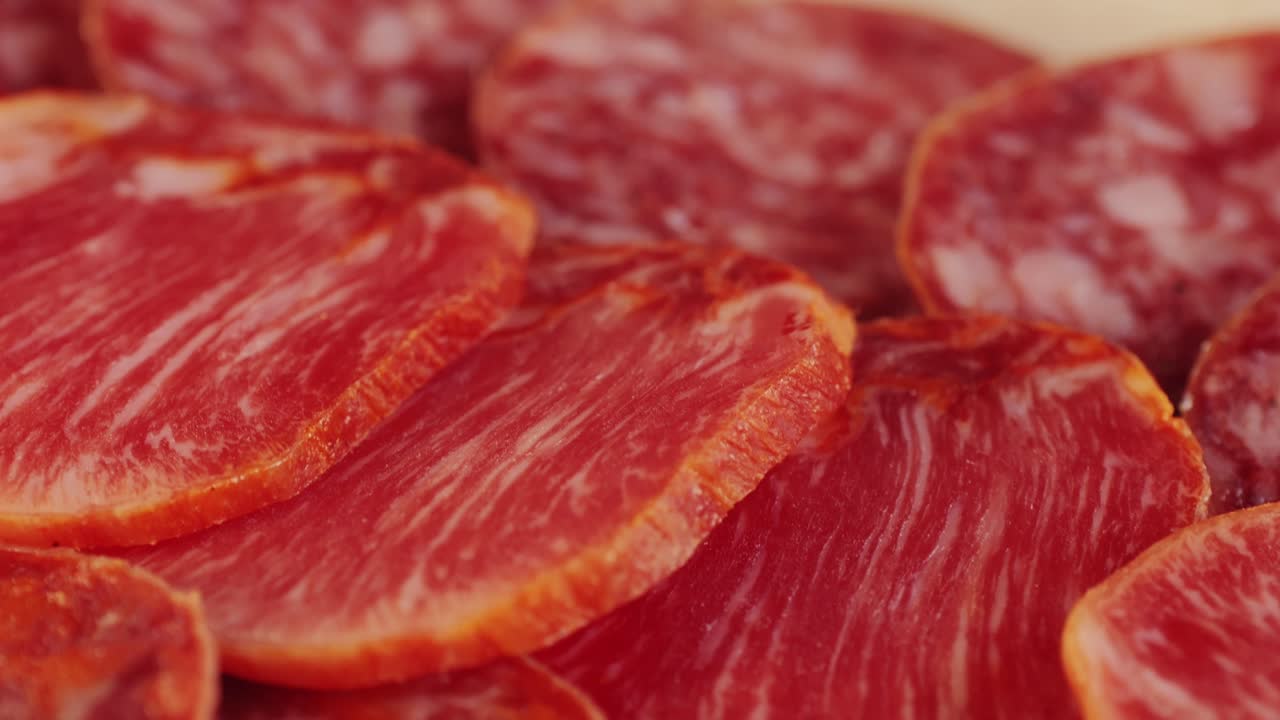 Mix of spanish pork sausages, Cutting board of appetizing catalonian snack - fuet, jamon, chorizo, olives, supermarket tapas food in spain, traditional cuisine.