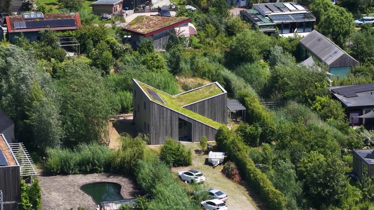 Vista aerea di un ecovillaggio ad Almere, che mostra abitazioni sostenibili, agricoltura urbana, pannelli solari, vita autosufficiente ed energia rinnovabile nei Paesi Bassi.