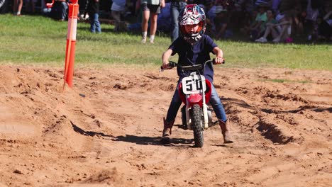 child racer competes in motocross event