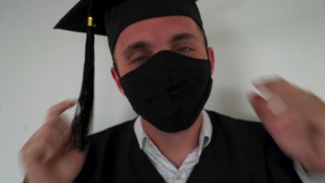 Close-Up-Shot-of-Smiling-Graduate-Wearing-a-Black-Protective-Mask-with-Graduation-Cap-and-Gown