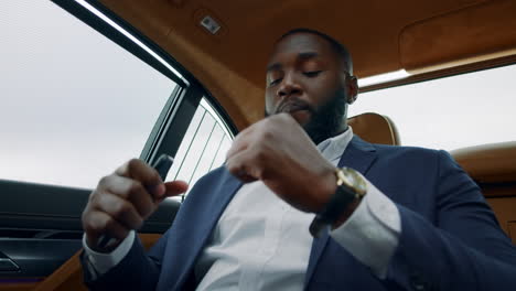 coseup african man dancing in car. afro businessman listening music in vehicle