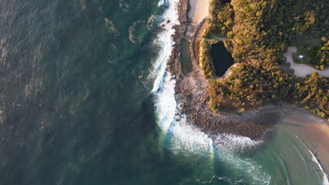 flying above natural rock pools of angourie with ocean views in new south wales, australia