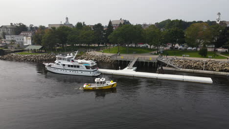 small tow, tug boat coming to berth at the city of bath, maine