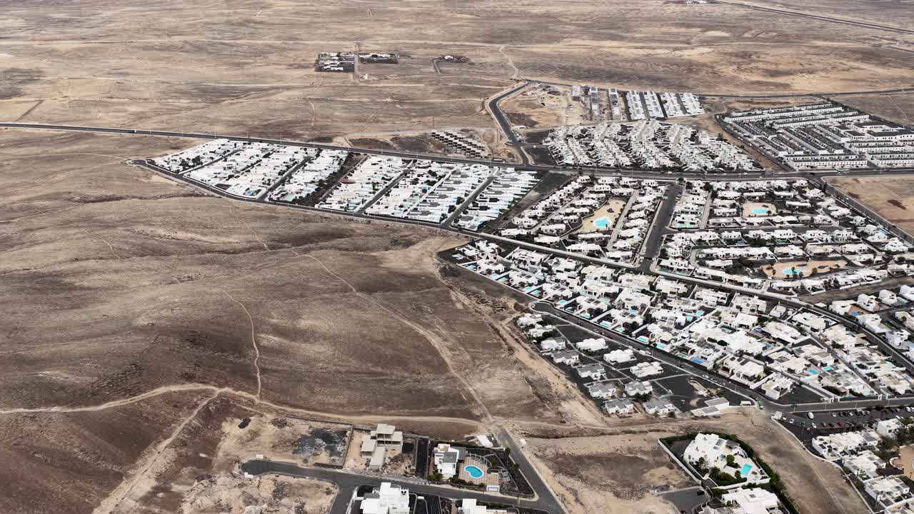Vibrant Lanzarote villa town aerial view establishing Montana Roja and Playa Blanca properties below