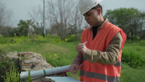 engineer looking around the construction site and taking notes