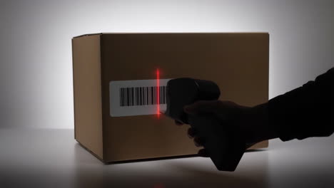 scanning a barcode on a package with a handheld scanner