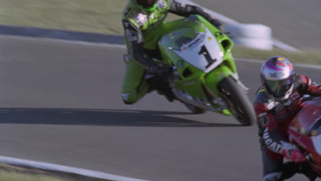 motorcyclists race around a track 2