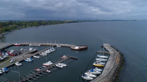 sailboats and luxury yachts docked at the marina in a town in scania county, sweden