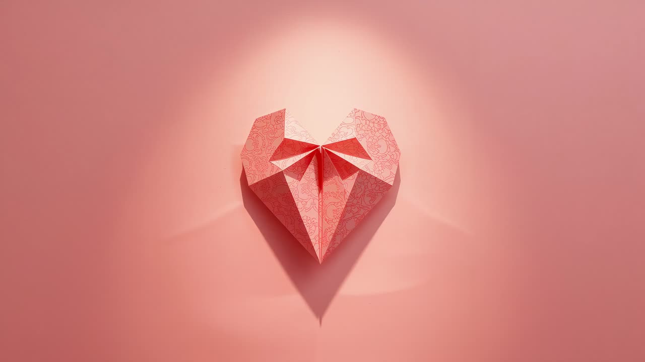 Brightening studio spotlight forming wider halo and deepening V shadow under pink origami heart