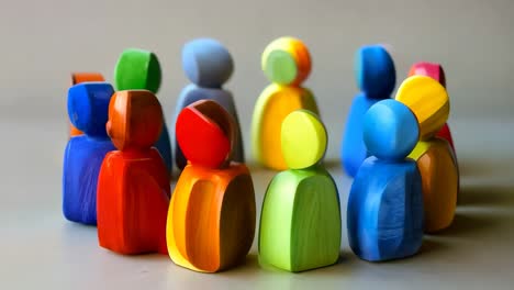 a group of colorful wooden people standing in a row