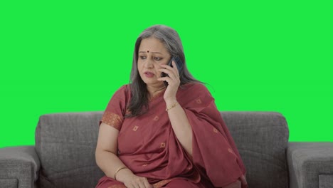 Indian-old-woman-talking-on-call-Green-screen