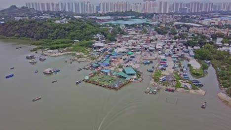 a dynamic ascending aerial footage of the fishing village in lau fau shan in the new territories of hong kong