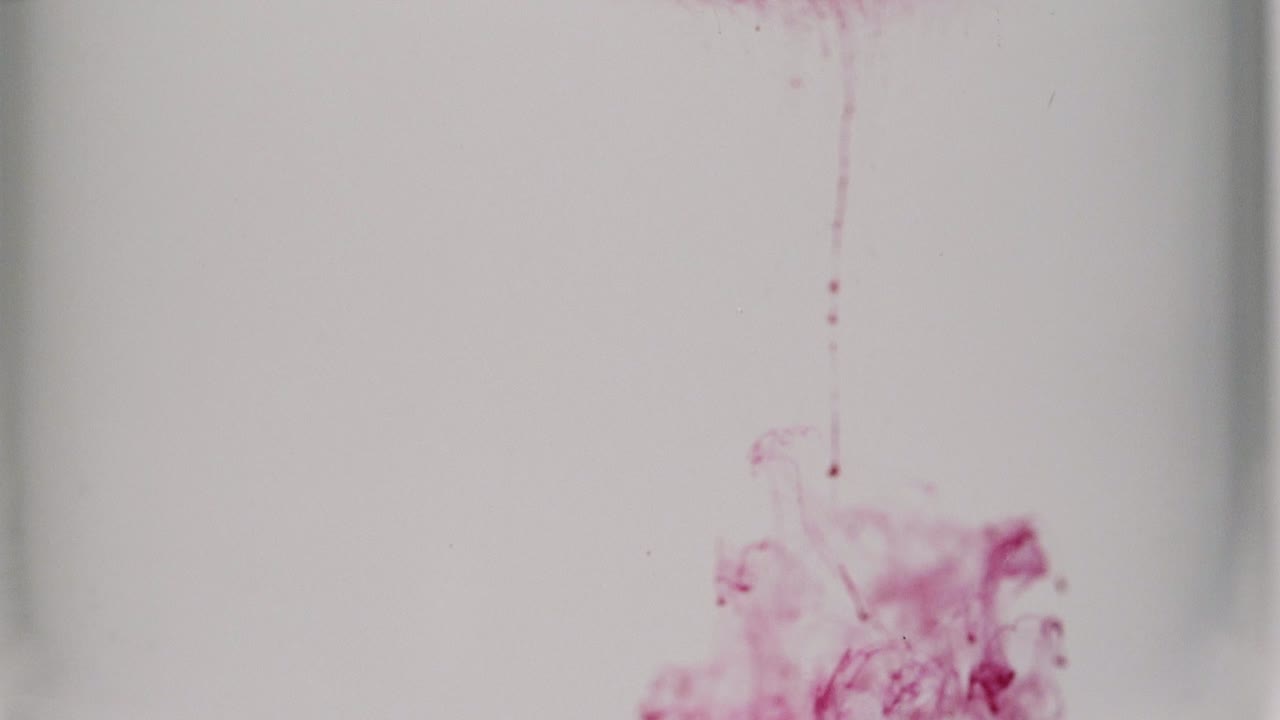 Red paint dissolving in water shot in slow motion with Sony a7iii.